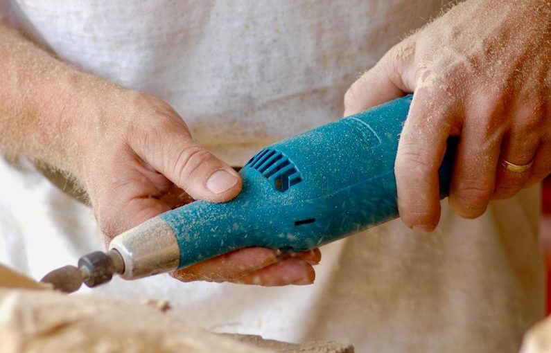 Wabi-Sabi Carving - person holding blue power tool