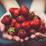 Spiritual Icons - shallow focus photography of strawberries on person's palm