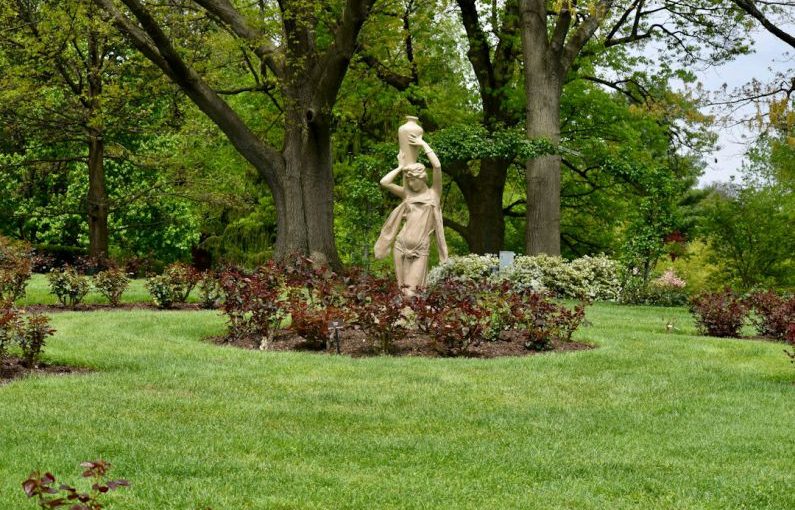 Garden Sculpture - a statue of a woman in a garden