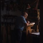 Lovespoon Carving - a man working in a shop