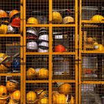 Safety Gear - a rack filled with lots of yellow hard hats