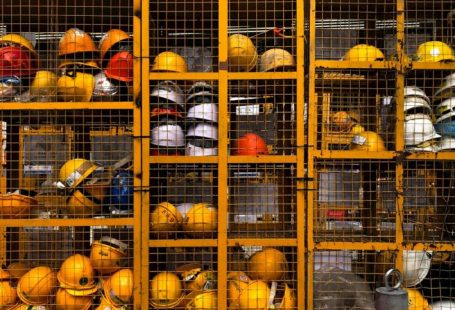 Safety Gear - a rack filled with lots of yellow hard hats