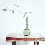 Beginner Wood - green glass vase on brown wooden table