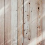 Intarsia Wood - a close up of a wooden wall with a light shining on it